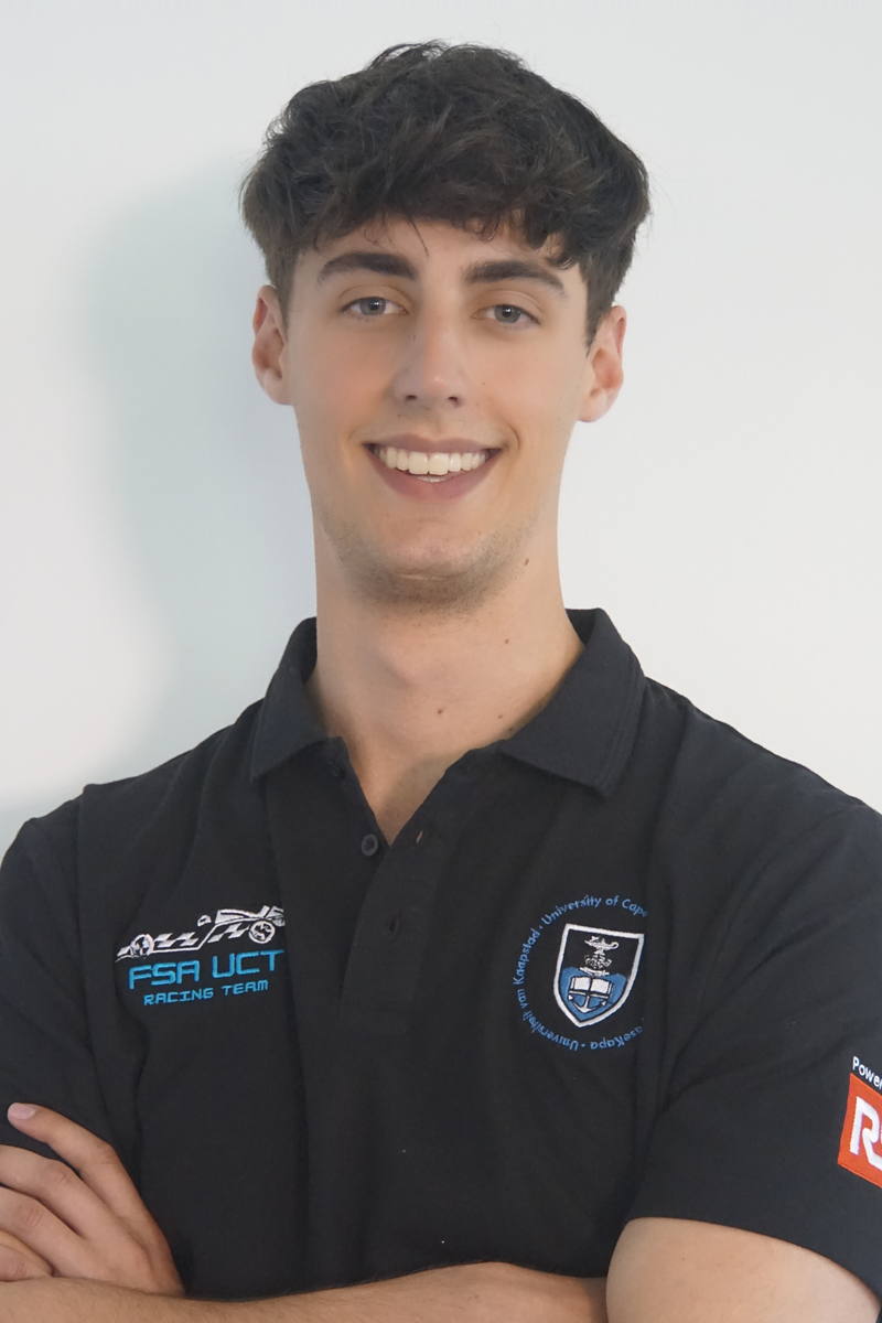 Adam Shames, arms folded, in a black UCT Racing team polo.