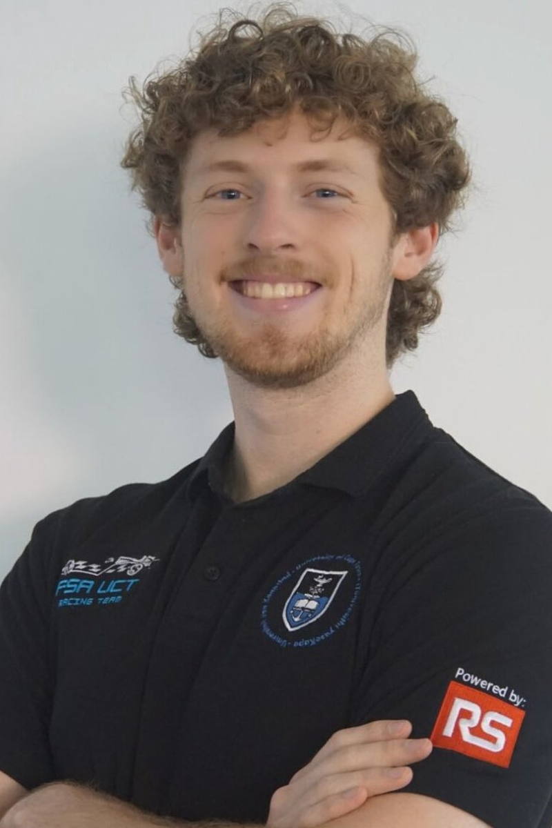 Phoenix Tennant, arms folded, in a black UCT Racing team polo.